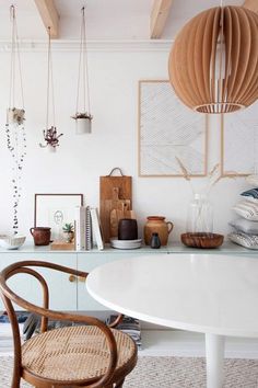 an instagram photo of a dining room with chairs and pictures hanging on the wall