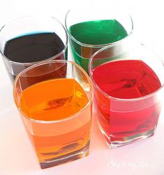 three glasses filled with different colored liquid