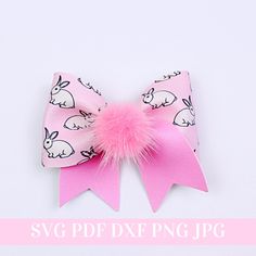 a pink bow with white rabbits on it and a pink pom - pom