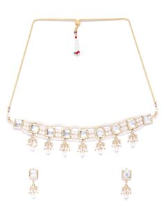 This beautiful jewelry set consists of a classic kundan choker necklace and a pair of matching drop earrings. The white pearl necklace shown here comes with kundan stone studs & off-white beads, is gold-plated, and secured with an adjustable drawstring closure. A pair of matching drop earrings come secured with a post and back closure. This statement piece is surely a classic, and can add impact to any outfit for any festive occasion! Product color may vary based on the monitor or screen you are White Adjustable Kundan Necklace For Festive Occasion, Festive White Adjustable Kundan Necklace, Festive Adjustable White Necklace, Elegant White Adjustable Kundan Necklace, White Pearl Chain Jewelry Sets For Festive Season, White Pearl Kundan Necklace For Diwali, White Kundan Choker Necklace In Temple Jewelry Style, Festive White Kundan Necklace With Pearl Drop, White Pearl Kundan Necklace With Meenakari