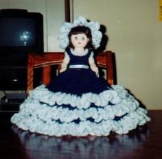 a doll sitting on top of a wooden table