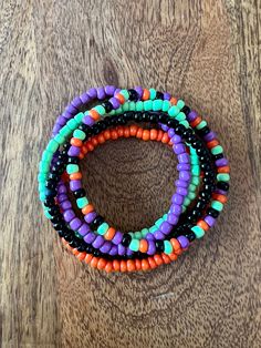 multicolored beaded bracelets on wooden surface