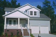 a white house with two garages in front of it