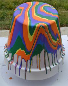 a colorful cake sitting on top of a white table