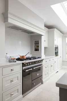 a kitchen with white cabinets and an oven