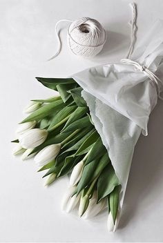 a bouquet of white tulips tied to a napkin