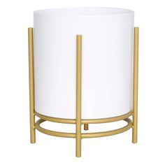 a white and gold planter on a stand