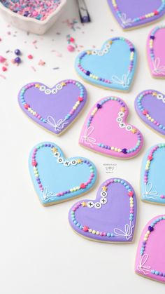 decorated heart shaped cookies sitting on top of a table