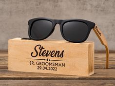 a pair of black sunglasses sitting on top of a wooden box with the name stevens