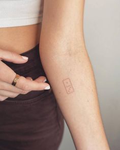 a woman's arm with a small tattoo on the left side of her body