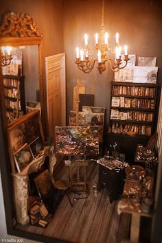 a room filled with lots of books and paintings