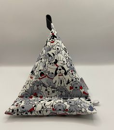 a triangle shaped object with cats and dogs on it's sides, sitting in front of a white background