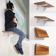 a man sitting on top of a wooden shelf next to two shelves and one shelf