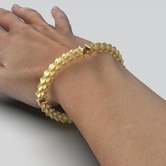 Discover Italian craftsmanship at its finest with our 14k or 18k Gold Desert Dunes Bracelet. Semi-rigid, clasp-free, and made to order in Italy, this exquisite piece features 4 modules adorned with a desert dunes pattern. Choose your preferred gold color and enjoy 100% made in Italy luxury. Material: Premium 14k or 18k gold Style: Semi-rigid, clasp-free for easy wear Inner Circumference Options: 7.4 inches or 8 inches (customizable) Gold Options: Choose from yellow, white, or rose gold Design: 4 Modern 14k Gold Jewelry With Box Clasp, 14k Gold Bracelet With Box Clasp, Modern 14k Gold Flexible Jewelry, Modern Flexible 14k Gold Jewelry, Unique Yellow Gold Bracelets For Formal Occasions, Unique Yellow Gold Formal Bracelets, Luxury Yellow Gold Nugget Jewelry, Unique Formal Yellow Gold Bracelets, Unique Yellow Gold Bangle Bracelet