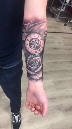 a person with a clock tattoo on their arm