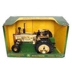 an old model tractor in a green box