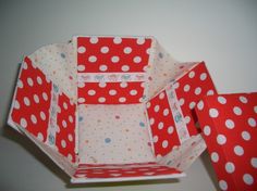 an origami box with polka dots on it