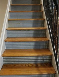 the stairs are painted blue and have wooden treads