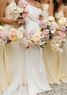 four bridesmaids holding bouquets of flowers in their hands