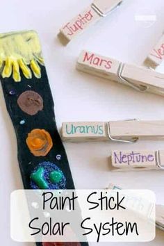 the word paint stick solar system is shown with clothes pins and magnets attached to it