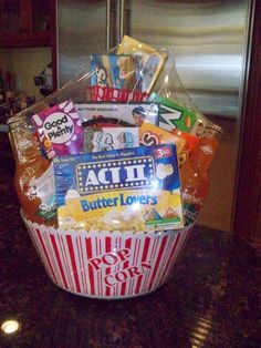 a popcorn bucket filled with snacks and condiments