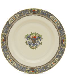 an ornately decorated plate with blue and gold trimmings on the rim,