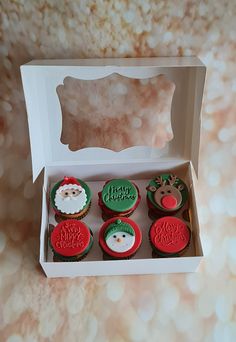 cupcakes decorated with christmas decorations in a box