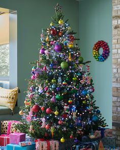 a brightly colored christmas tree with presents under it