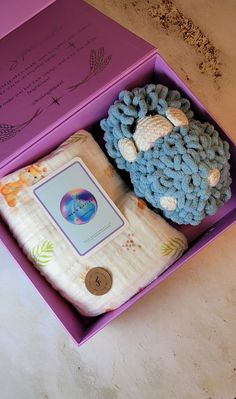 a stuffed animal in a purple box on a table