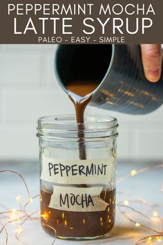 peppermint mocha latte syrup is being poured into a mason jar with labels on it