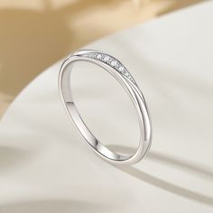 Simply and chic, this band is a clever accessory you will love. Featuring white stones, this band is an elegant symbol of your marital commitment. Buffed to a brilliant luster, this comfort-fit wedding band  will make your vows shine.Carat Weight: 0.086 ctStone Size: 1.1,1.3,1.5 mmStone Type: Jeulia® StoneNumber of Stones: 5 Stone Color: Diamond WhiteStone Shape: RoundWeight: 1.6 gWidth: 1.8 mmHeight: 1.8 mmThickness: 1.1 mmMaterial: 925 SilverPlating Color: Silver Elegant Symbol, Comfort Fit Wedding Band, White Stones, White Stone, Wedding Things, Quality Jewelry, Wedding Band, Stone Color, Round Cut