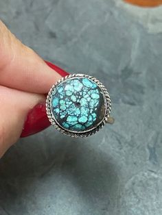 Simple and stunning, this sweet little ring boasts a 1/2" round, webbed, Cloud Mountain Turquoise stone. The veining in the stone is so cool! The stone is set in Sterling Silver with braid detail around the edge. Straight shank, minimalist band makes this ring so easy to wear. Size 8 1/2 US. Signed LQ on bottom of ring and 925 on inside of band. Weighs .2 oz. There is tarnish on the bottom of the ring and a little round circle in the middle of the stone - not sure what that is about but it came to me that way. Cloud Mountain Turquoise comes from a mine in the Hubei Province of Central China. Very distinct and unique stone. Beautiful gift! Adjustable Rings With Natural Stones, Unique Adjustable Nickel-free Turquoise Ring, Bohemian Adjustable Rings With Round Stone, Unique Turquoise Promise Ring, Spiritual Round Turquoise Ring, Adjustable Spiritual Turquoise Ring, Turquoise Round Band Ring As Gift, Adjustable Turquoise Ring With Natural Stones, Adjustable Turquoise Ring With Natural Stones For Promise