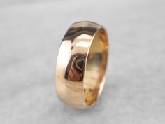 This vintage unisex wedding band is crafted from 18 karat gold and has a beautiful warmth to it! The rounded design feels comfortable on the finger, while the simplicity of style makes this ring timeless for years to come.Metal: 18K Yellow GoldWidth of Band: 6.5 mmHeight off Finger: 1.0 mmRing Size: 6.75Marks: "HC 18" and special characters stamped on the inside band Classic Couple Rings In Yellow Gold With Thick Band, Classic Yellow Gold Couple Rings With Thick Band, Classic Oval Wide Band Ring For Wedding, Classic 14k Stamped Couple Rings, Wide Band Ring With Polished Finish For Wedding, Oval Wide Band Ring With Polished Finish For Wedding, Classic Rose Gold Wide Band Ring, Heirloom Style Wide Band Formal Ring, Classic 14k Wide Band Ring For Wedding