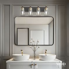 a bathroom with two sinks and a large mirror