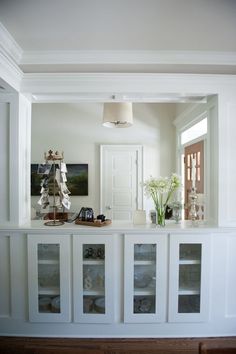 a living room with white walls and glass doors