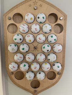 a wooden clock with lots of white balls on it