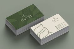 two business cards with green leaves on them