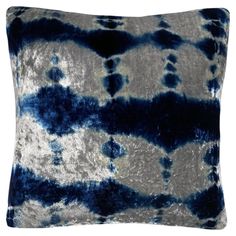 a blue and white pillow with black spots on it