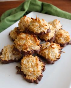 chocolate covered cookies on a white plate with green napkin