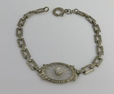 Estate art deco 1920's 14k white gold diamond camphor glass bracelet. great shape. fits up to 7.75 inchs. 5.6 grams. marked 14k. small old cut diamond approx 5pts. fine art deco bracelet. carved rock crystal camphor glass piece. Vintage Platinum Diamond Bracelet For Formal Occasions, Art Deco White Gold Bracelet For Formal Occasions, Formal Art Deco White Gold Bracelet, Art Deco White Gold Bracelets For Evening, Art Deco White Gold Diamond Bracelet, Vintage Silver Diamond Bracelet In Platinum, Vintage Platinum Diamond Bracelet, Vintage Diamond Cut Bracelet For Wedding, Vintage White Gold Diamond Bracelet