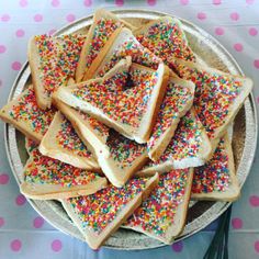 a plate full of sprinkle covered sandwiches