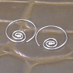 Silver Swirl Hoops Sterling Goddess Feminine Pretty Tribal One Inch Hoop Earrings BoHo Sheek Earthy Elegance Even in stillness the Goddess knows the continual motion of the Divine. Argentium sterling silver whirls around a single Goddess Tear - this universal design is simple and elegant and will hang 1 inch from your piercing.  These are made from 20g sterling silver, which is the standard North American ear wire size - so they will fit the average piercing.   A lovely addition to your earring Spiral Earrings For Festivals, Adjustable Spiral Hoop Earrings, Bohemian Adjustable Spiral Hoop Earrings, Goddess Feminine, Boho Sheek, Earthy Elegance, Earring Collection, Cleaners Homemade, Universal Design