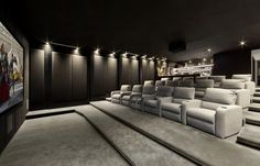 an empty movie theater with white seats