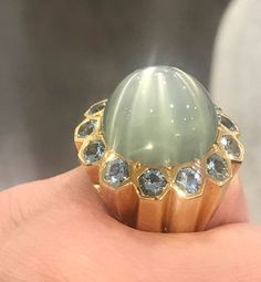 Such a glamorous ring to wear! With an alluring 53.50 carat moonstone in the center, surrounded by 7.8 carats of crystal blue aquamarine. All set in 18k yellow gold. Size: 6 Weight: 40 grams Luxury Multi-stone Moonstone Ring, Luxury Multi-stone Round Moonstone Ring, Luxury Blue Moonstone Ring, Yellow Gold Multi-stone Moonstone Ring For Anniversary, Luxury 14k Gold Moonstone Ring For Formal Occasion, Luxury 14k Gold Moonstone Ring For Formal Events, Luxury Multi-stone Moonstone Ring In Yellow Gold, Luxury Oval Moonstone Ring For Anniversary, Formal Celestial Style Sapphire Ring