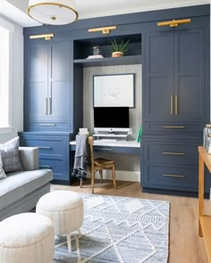 a living room filled with furniture and a flat screen tv on top of a desk