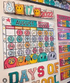 a wall with calendars on it and colorful lettering that says days of the week