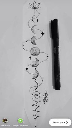 a pen is sitting on top of a piece of paper that has the moon and stars drawn