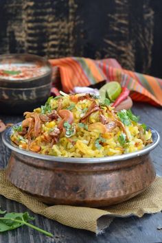 a bowl filled with food sitting on top of a wooden table