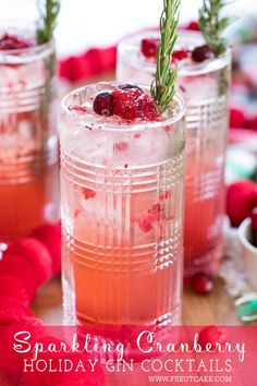 two glasses filled with cranberry punch and rosemary sprigs