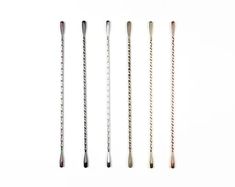 four different types of knitting needles on a white background